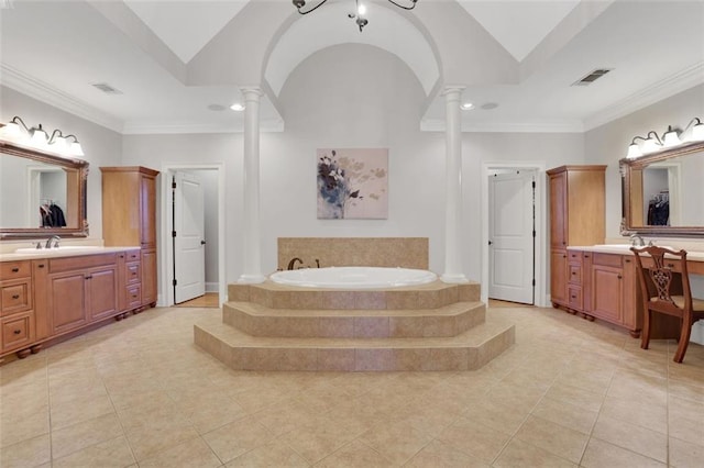 bathroom with two vanities, a bath, tile patterned floors, and ornate columns