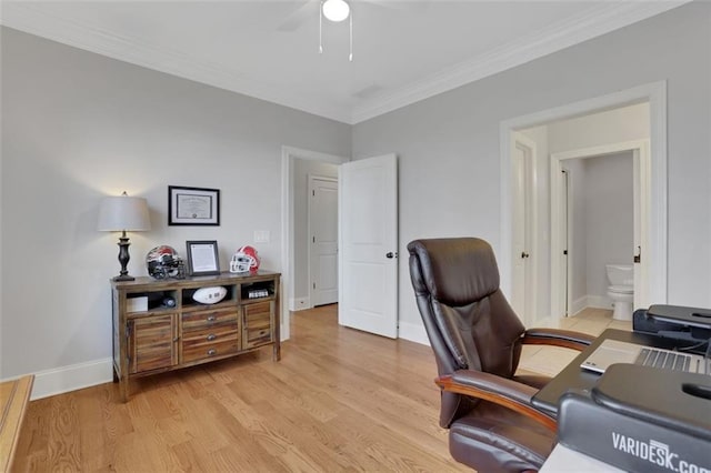 home office with crown molding, light wood-type flooring, a ceiling fan, and baseboards