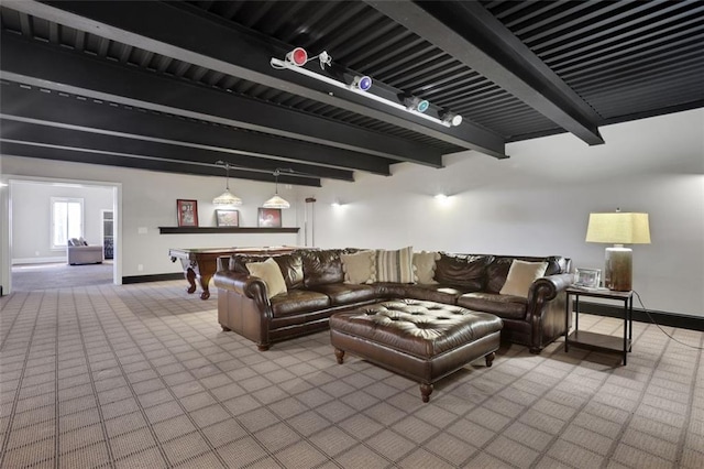 carpeted living room with beamed ceiling and baseboards