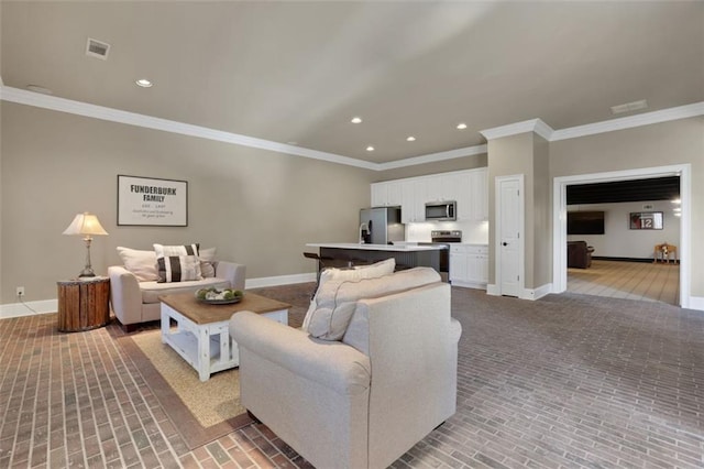living area with baseboards and ornamental molding