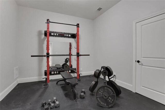 workout room featuring baseboards and visible vents