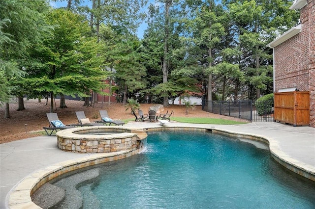 view of pool with fence, a pool with connected hot tub, a patio area, and a diving board