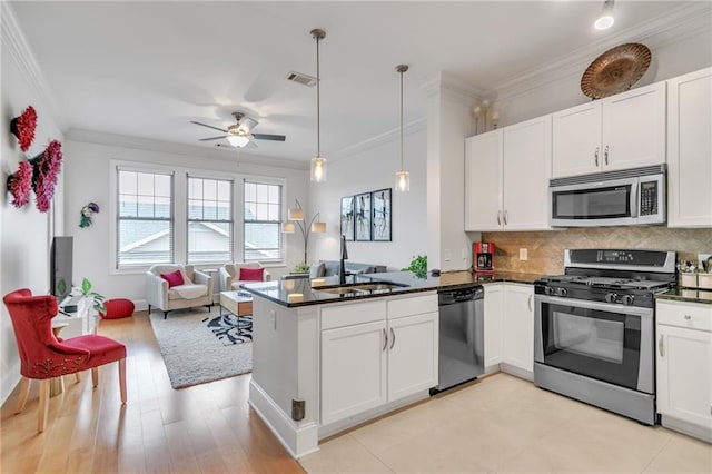 3621 Vinings Slope SE Unit 1537, Atlanta, GA 30339 - kitchen with appliances with stainless steel finishes, a sink, crown molding, a peninsula, and open floor plan
