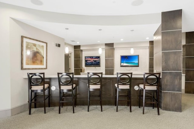 bar with decorative light fixtures and light colored carpet