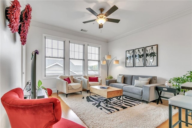 living room featuring ceiling fan, wood-type flooring, and ornamental molding