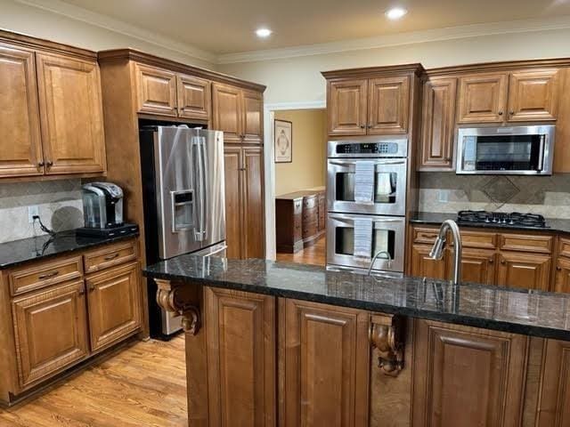 kitchen with appliances with stainless steel finishes and brown cabinets