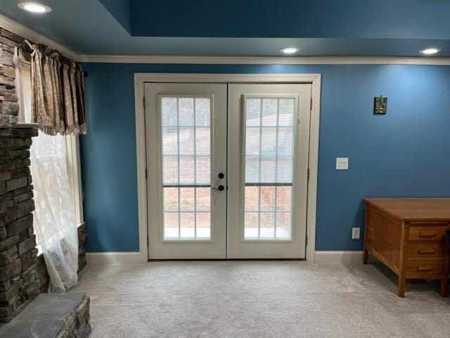 doorway featuring a wealth of natural light, crown molding, carpet flooring, and french doors