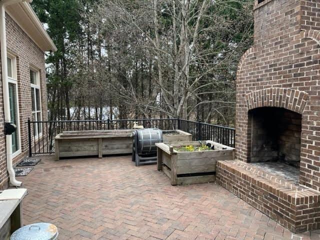 view of patio / terrace with an outdoor brick fireplace