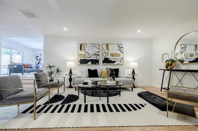 living room with baseboards, recessed lighting, visible vents, and wood finished floors
