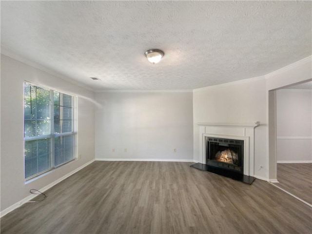 unfurnished living room featuring a textured ceiling, hardwood / wood-style floors, and crown molding