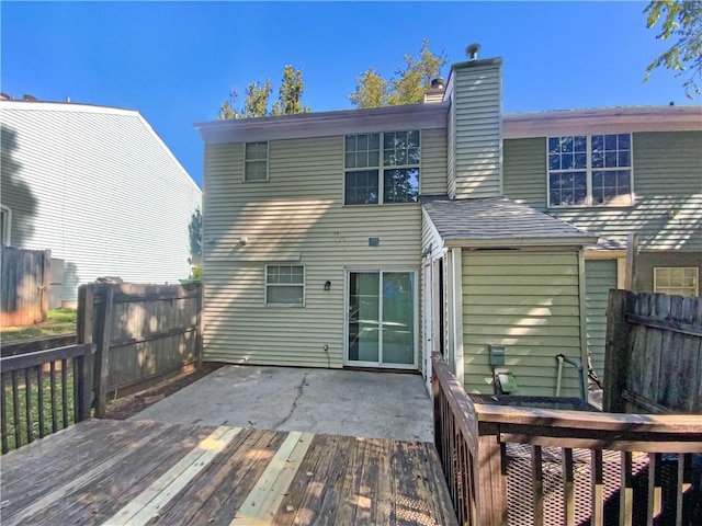 rear view of house featuring a patio and a wooden deck