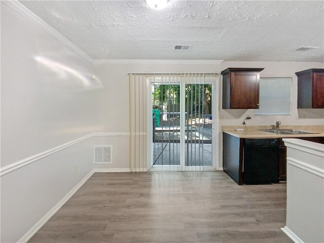 kitchen with light hardwood / wood-style floors, crown molding, black dishwasher, and sink