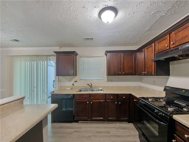 kitchen featuring light hardwood / wood-style flooring, a textured ceiling, black appliances, and sink