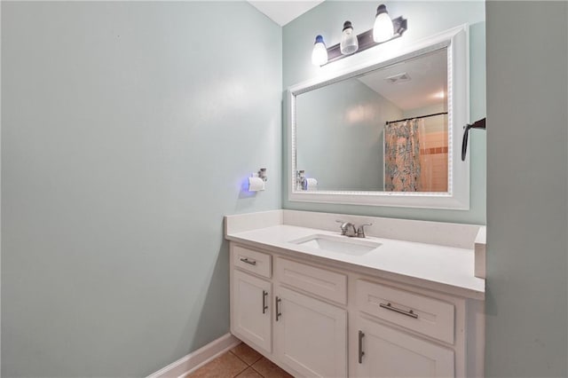 bathroom featuring a shower with curtain, vanity, baseboards, and tile patterned floors