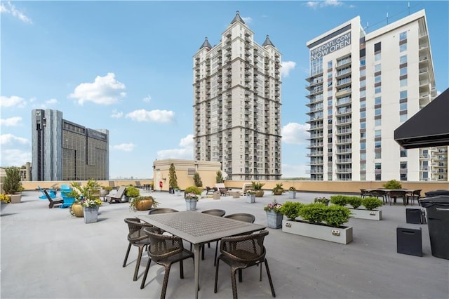 view of patio / terrace with outdoor dining area and a city view