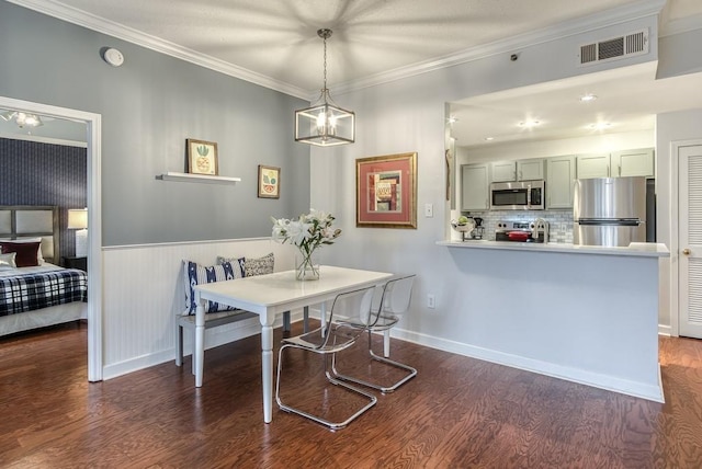 dining area with dark wood-style floors, visible vents, breakfast area, and ornamental molding