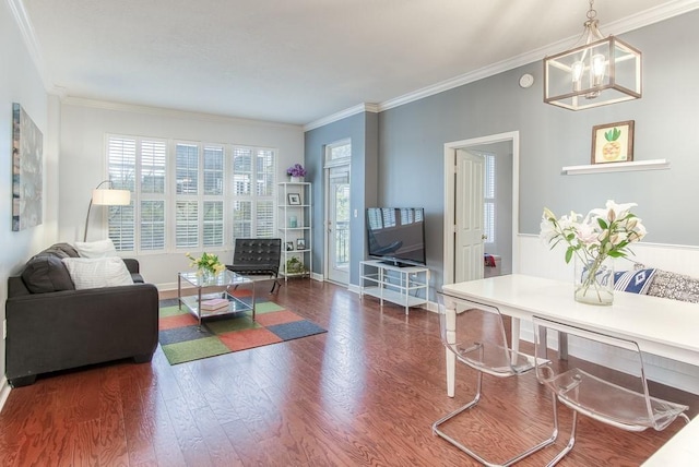 living room featuring ornamental molding, an inviting chandelier, and dark hardwood / wood-style floors