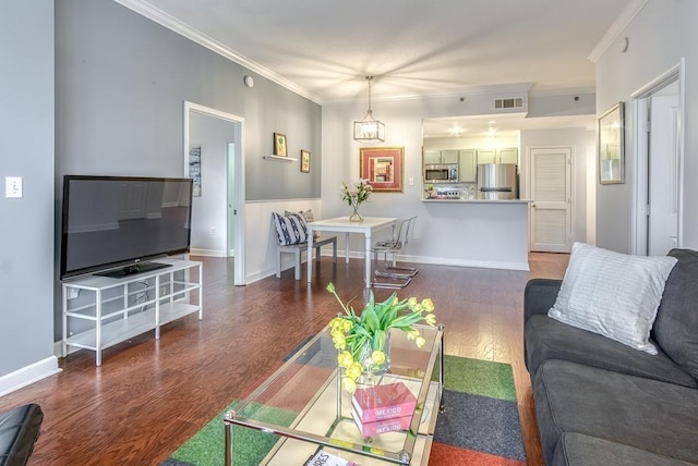 living area featuring ornamental molding, dark wood finished floors, visible vents, and baseboards