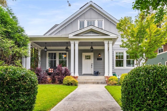 1338 Iverson St NE, Atlanta, GA 30307 - view of front of house with board and batten siding, covered porch, and a front lawn