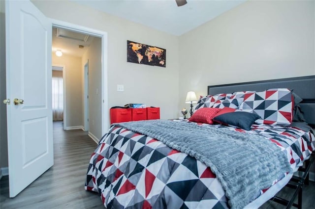 bedroom with ceiling fan, baseboards, and wood finished floors