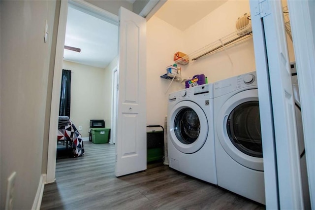 laundry area featuring laundry area, baseboards, dark wood finished floors, and washer and dryer