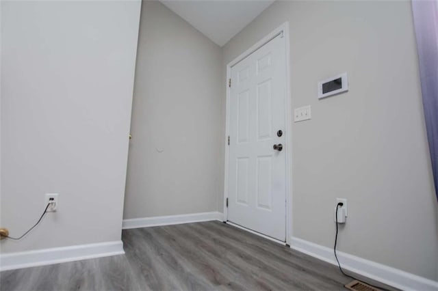 interior space featuring wood finished floors and baseboards