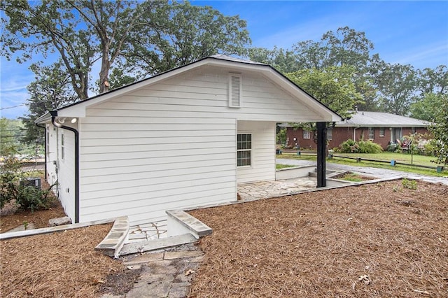 view of side of home featuring a patio area