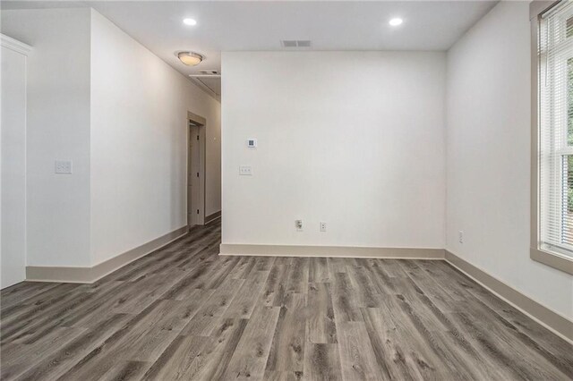 unfurnished room with recessed lighting, wood finished floors, visible vents, and a healthy amount of sunlight