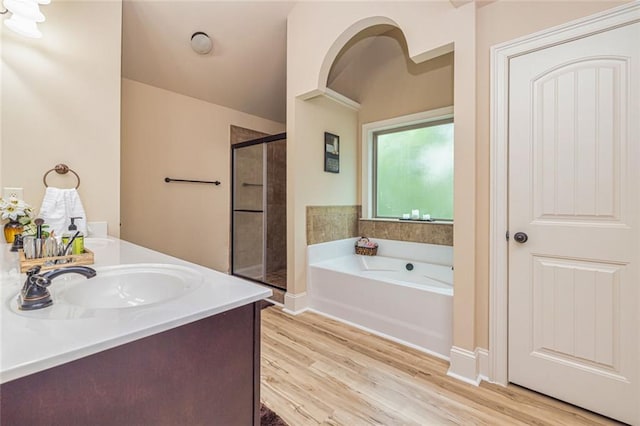 139 Village Park Dr, Newnan, GA 30265 - bathroom featuring a shower stall, a bath, wood finished floors, and double vanity