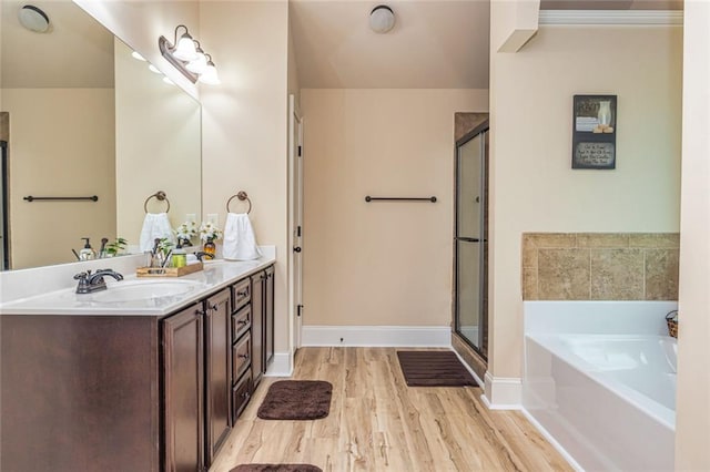 139 Village Park Dr, Newnan, GA 30265 - full bath featuring wood finished floors, double vanity, a bath, and a stall shower