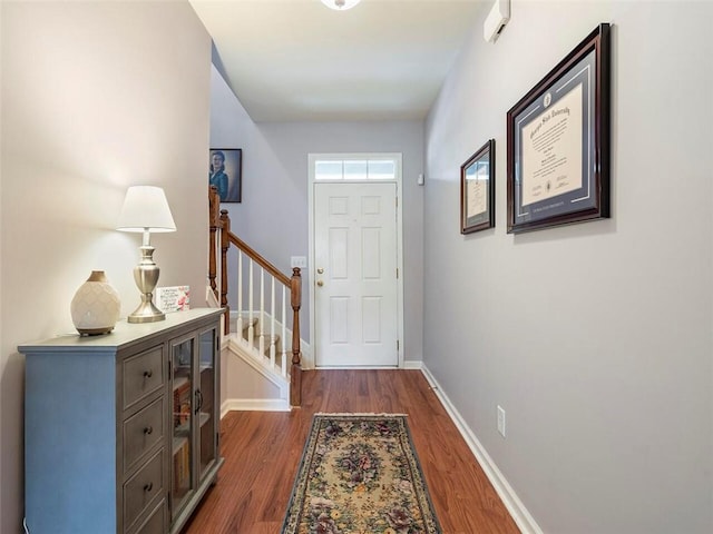 entryway with dark hardwood / wood-style flooring