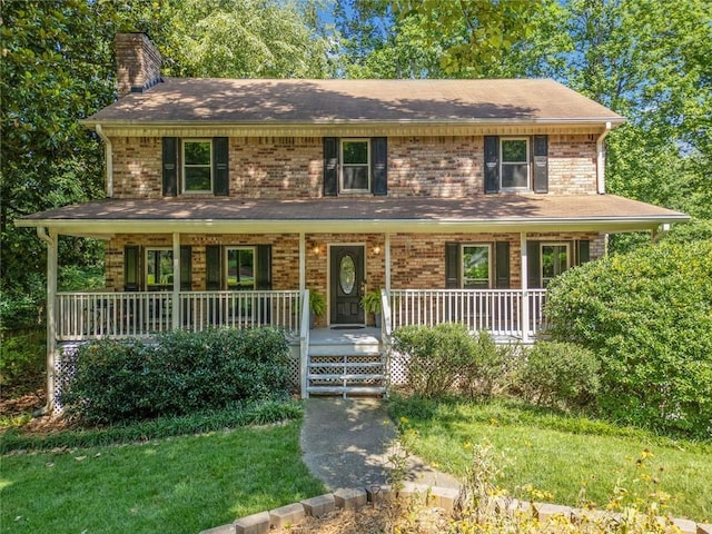 786 Mitsy Pt, Marietta, GA 30068 - view of front facade with covered porch, a chimney, brick siding, and a front yard