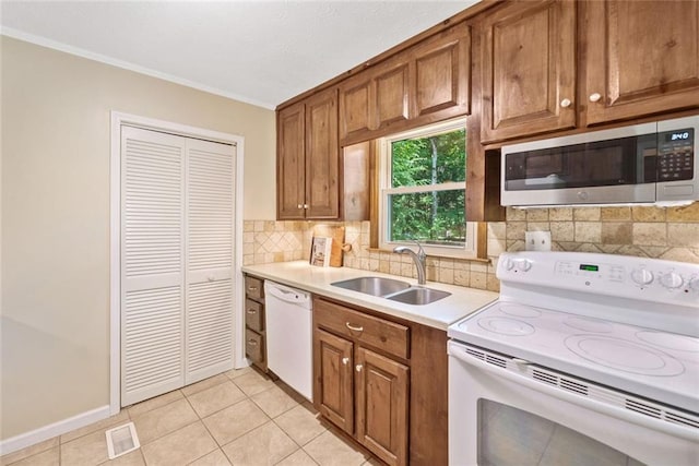 786 Mitsy Pt, Marietta, GA 30068 - kitchen with white appliances, light countertops, brown cabinets, tasteful backsplash, and crown molding