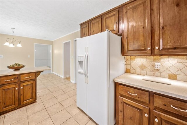 786 Mitsy Pt, Marietta, GA 30068 - kitchen with white refrigerator with ice dispenser, brown cabinetry, light tile patterned floors, a textured ceiling, and tasteful backsplash