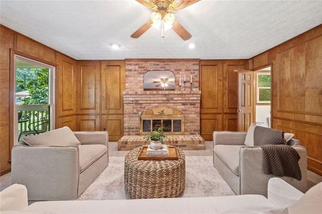 786 Mitsy Pt, Marietta, GA 30068 - living area featuring plenty of natural light, wooden walls, a ceiling fan, a brick fireplace, and a textured ceiling