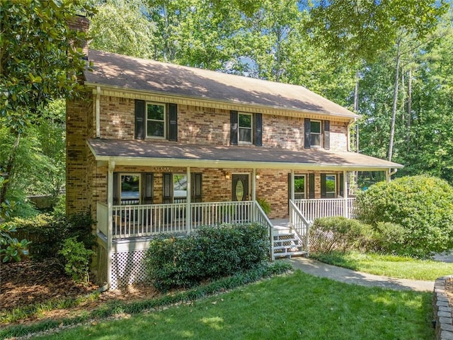 786 Mitsy Pt, Marietta, GA 30068 - view of front facade featuring a porch, a front lawn, brick siding, and a chimney