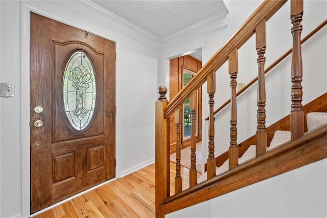 786 Mitsy Pt, Marietta, GA 30068 - entryway with wood finished floors, stairway, crown molding, and a textured ceiling