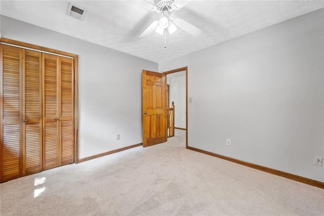 786 Mitsy Pt, Marietta, GA 30068 - unfurnished bedroom with light colored carpet, a closet, a textured ceiling, and a ceiling fan