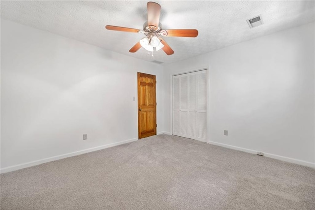 786 Mitsy Pt, Marietta, GA 30068 - unfurnished bedroom featuring a closet, carpet flooring, a textured ceiling, and a ceiling fan