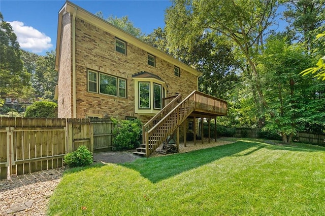 786 Mitsy Pt, Marietta, GA 30068 - back of property featuring stairs, a fenced backyard, a deck, brick siding, and a gate