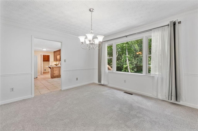 786 Mitsy Pt, Marietta, GA 30068 - spare room featuring a chandelier, light colored carpet, a textured ceiling, crown molding, and light tile patterned flooring