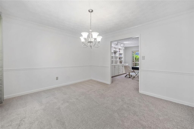 786 Mitsy Pt, Marietta, GA 30068 - carpeted spare room with a textured ceiling, crown molding, and a chandelier