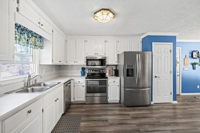 kitchen with sink, stainless steel appliances, dark hardwood / wood-style flooring, crown molding, and white cabinets