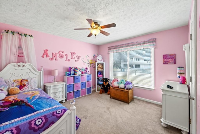 carpeted bedroom featuring ceiling fan and a textured ceiling