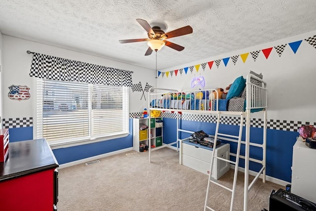 bedroom featuring ceiling fan, carpet, and a textured ceiling