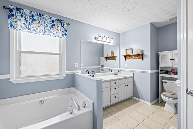 bathroom with vanity, a textured ceiling, a bath, tile patterned flooring, and toilet