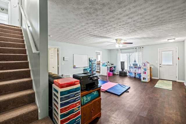 interior space featuring a textured ceiling, ceiling fan, and dark hardwood / wood-style floors