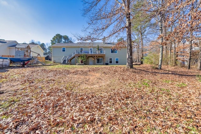 rear view of house featuring a wooden deck