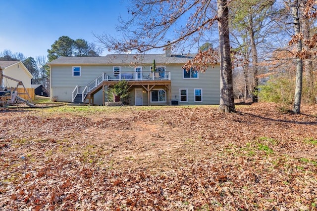 rear view of property with a wooden deck