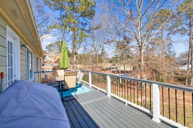 wooden deck featuring a grill